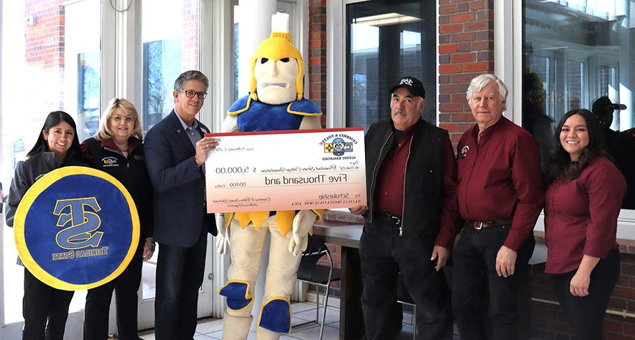 Scott Gibbs, president of the Cumbres & Toltec Scenic Railroad presents check to James Kynor, Vice President of the Valley Campus